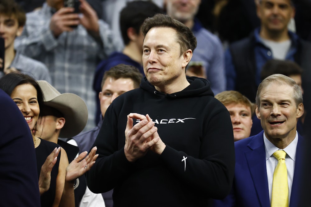 Elon Musk claps as Donald Trump enters the stadium during the Division I Men’s Wrestling Championship at the Wells Fargo Center.