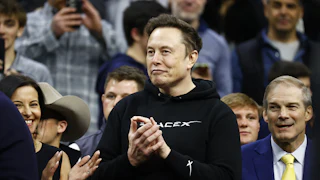 Elon Musk claps as Donald Trump enters the stadium during the Division I Men’s Wrestling Championship at the Wells Fargo Center.