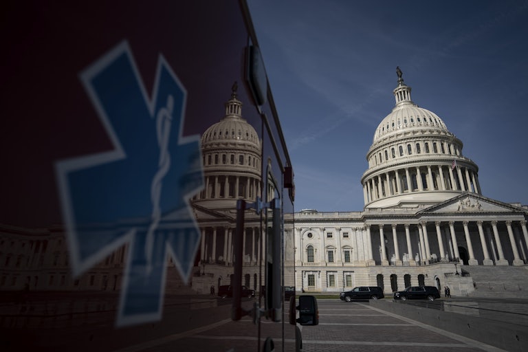 The U.S. Capitol is reflected on the side of an ambulance.