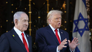 Donald Trump gestures and speaks while standing next to Israeli Prime Minister Benjamin Netanyahu