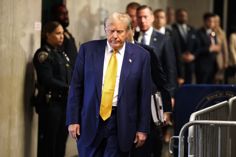 Donald Trump looks down as he walks