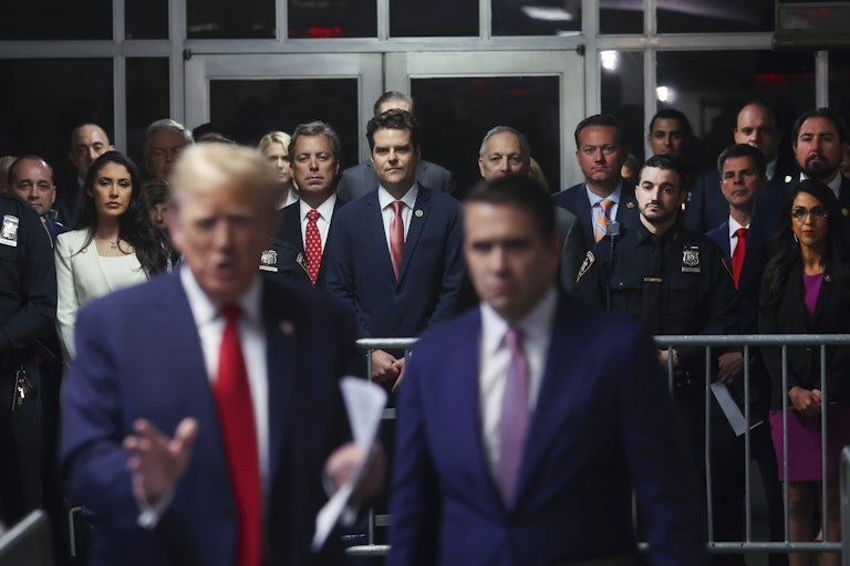 Anna Paulina Luna, Andy Ogles, Matt Gaetz, Lauren Boebert, and Eli Crane stand behind Donald Trump and Todd Blanche