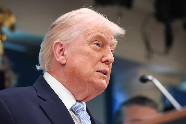Donald Trump speaks at a podium during a press conference
