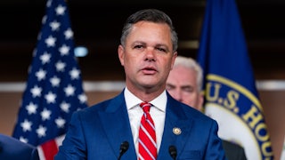 Representative Zach Nunn speaks at a podium during a press conference
