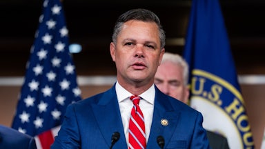 Representative Zach Nunn speaks at a podium during a press conference
