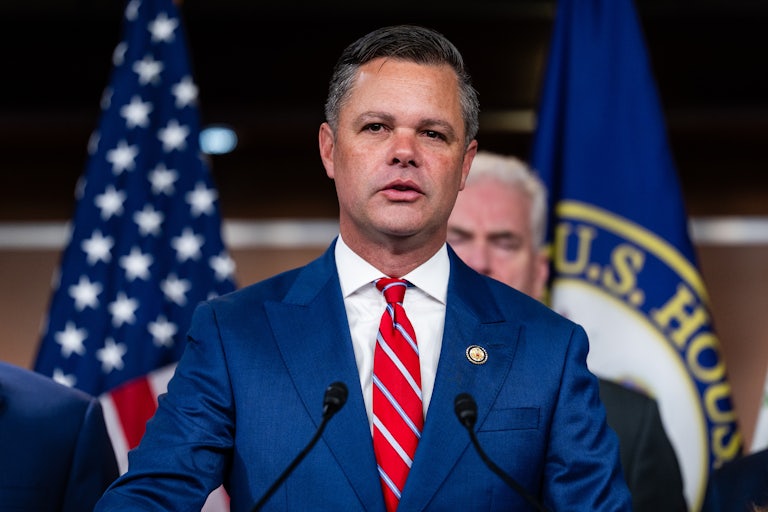 Representative Zach Nunn speaks at a podium during a press conference