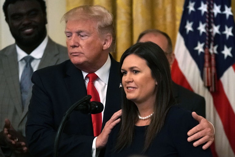 Donald Trump puts his hands on Sarah Huckabee Sanders' shoulders