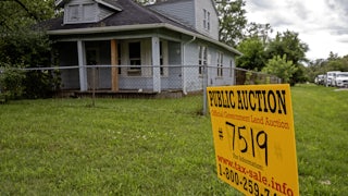 Southfield, Michigan, A sign advertises the upcoming online auction of a home foreclosed because of nonpayment of taxes.