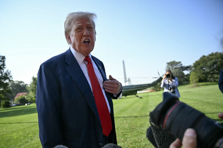 Donald Trump gestures at himself while speaking to reporters outside the White House