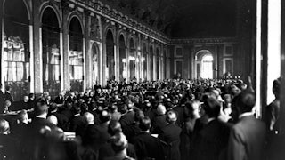 28th June 1919: Diplomats and delegates watching the signing of the Peace Treaty of Versailles in the Hall of Mirrors at Versailles in France.