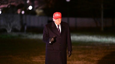 Donald Trump gives a thumbs up while walking outside the White House