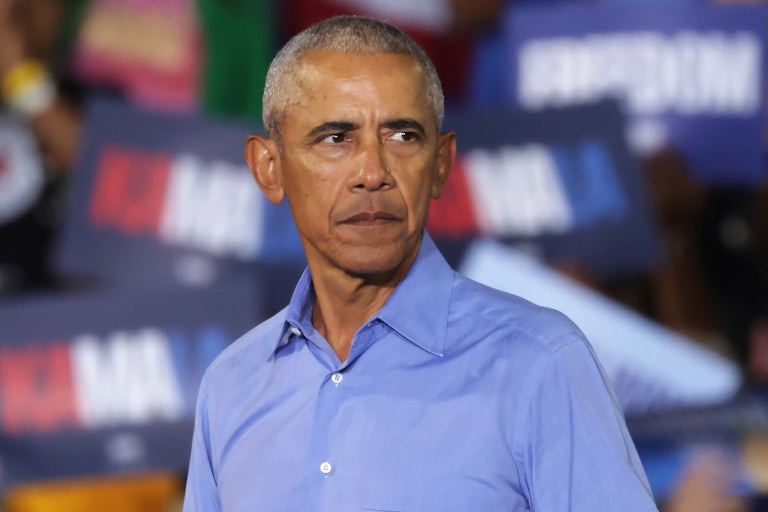 Barack Obama looks serious at a campaign rally.