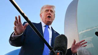 President Donald Trump speaks to reporters on the tarmac.