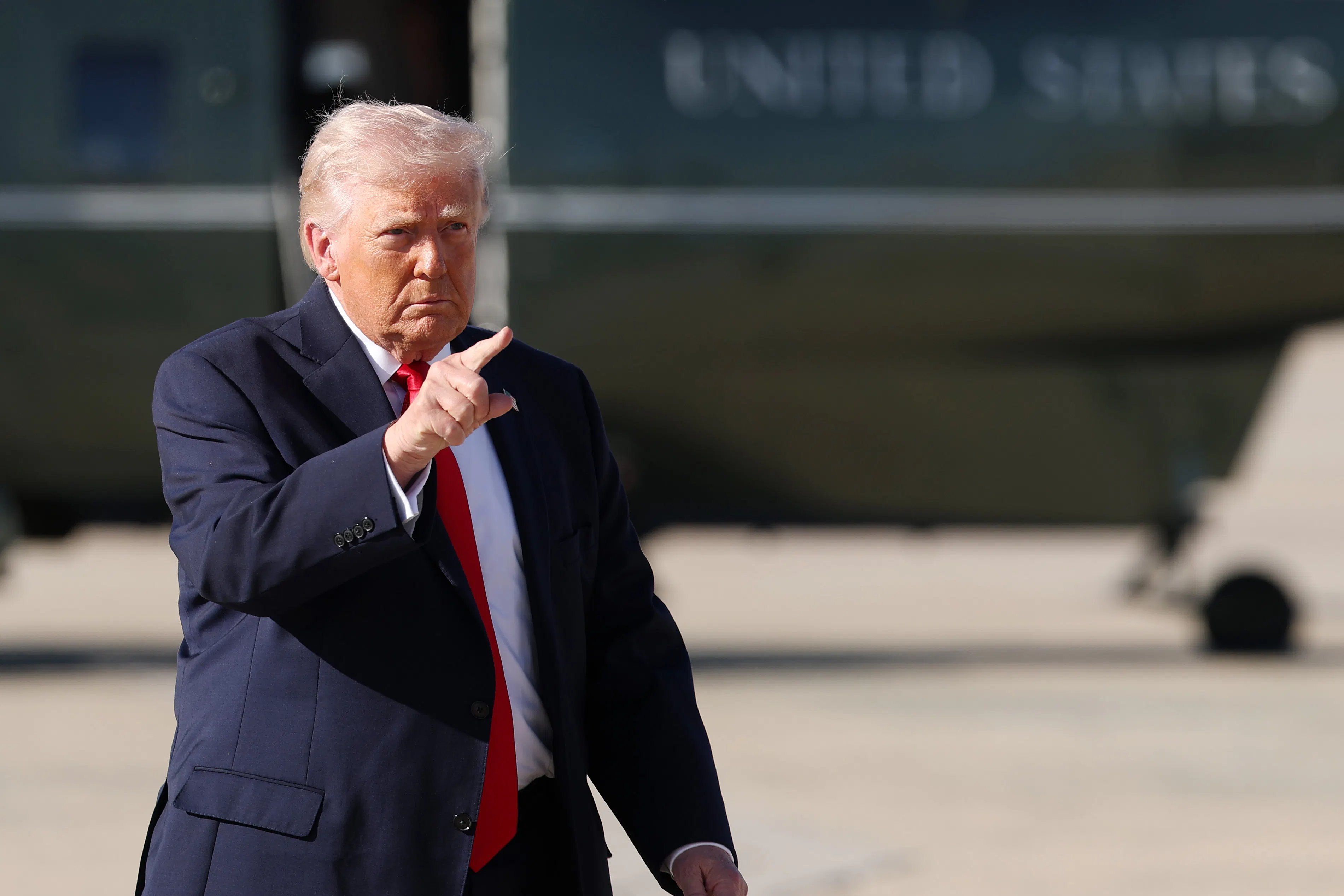 President Trump points while on the tarmac