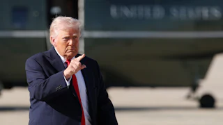 President Trump points while on the tarmac