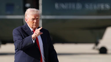 President Trump points while on the tarmac