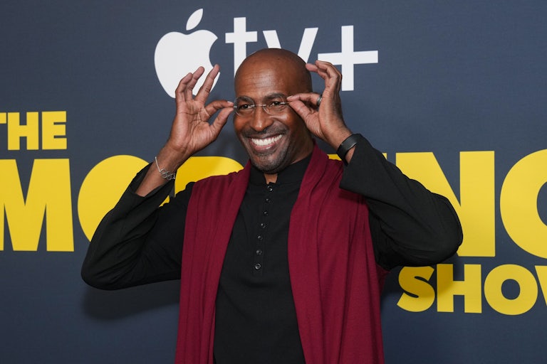 Van Jones attends "The Morning Show" premiere and smiles for the camera while adjusting his glasses.