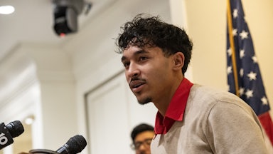 Marcelo Gomes da Silva speaks at a podium