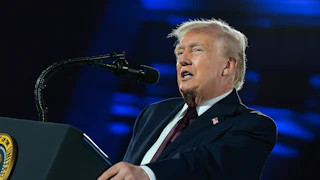 President Donald Trump speaking at a podium