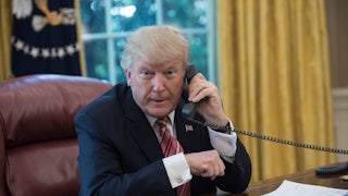 Donald Trump speaks on the phone in the Oval Office.