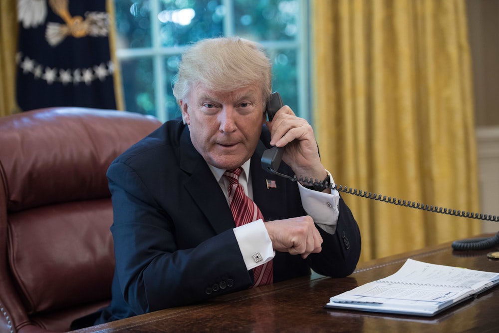 Donald Trump speaks on the phone in the Oval Office.