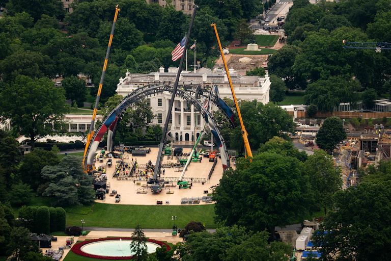 Workers construct a UFC fighting ring ahead on the South Lawn of the White House.