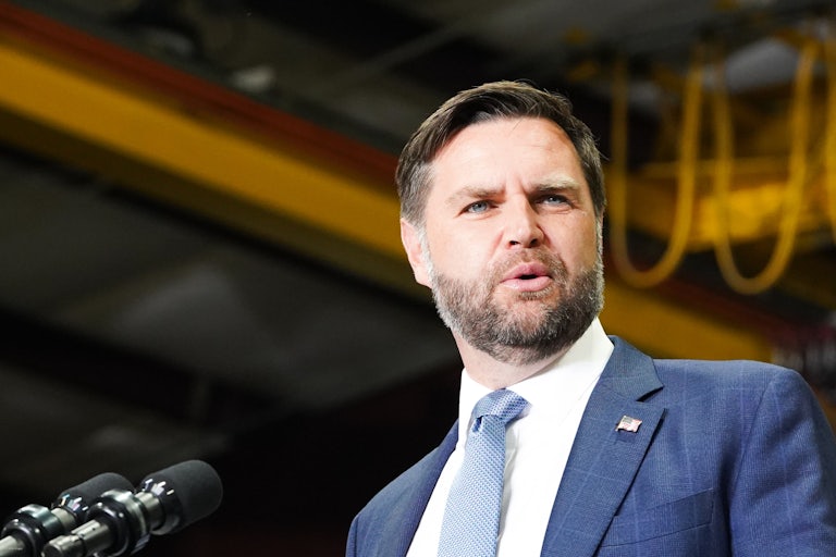 JD Vance looks confused while speaking at a podium.