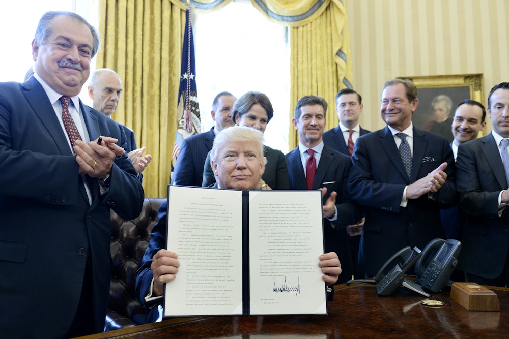 President Donald Trump flanked by business leaders