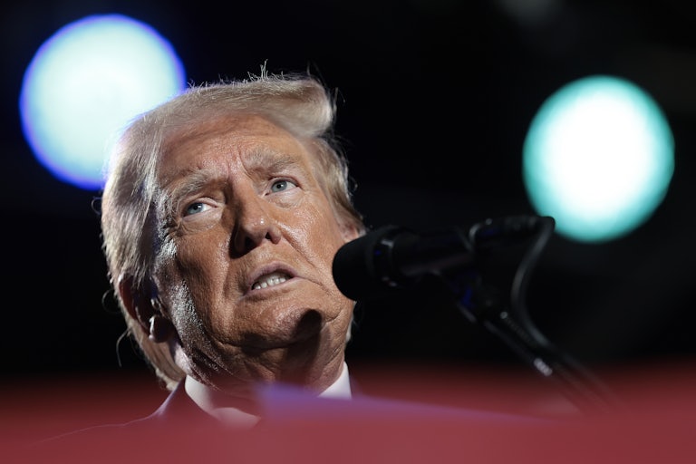 Trump speaks into a microphone