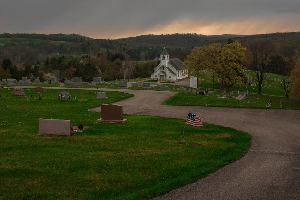 A church in Grant Township sits surrounded by rolling hills and a cemetery.