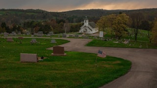 A church in Grant Township sits surrounded by rolling hills and a cemetery.