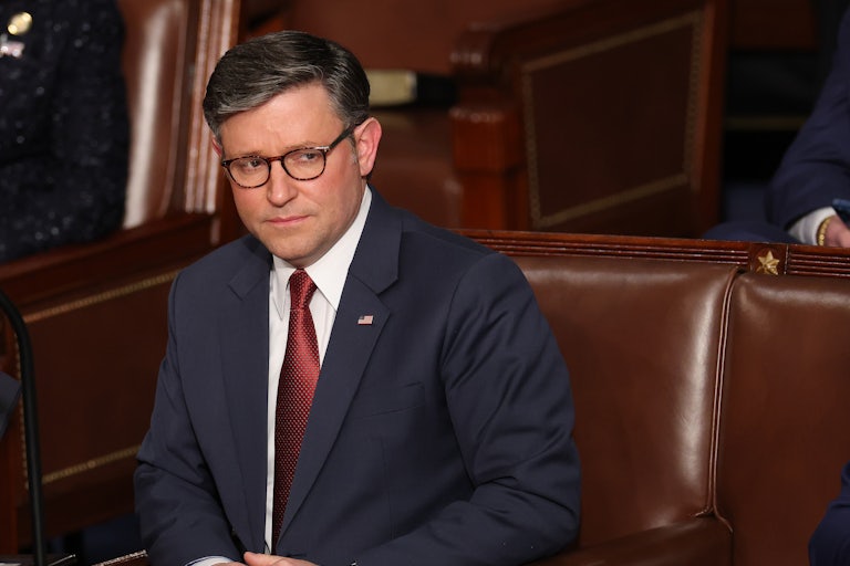 Mike Johnson frowns while sitting in Congress