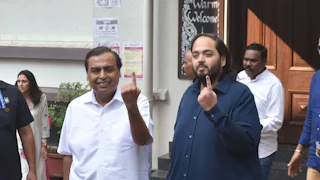 Reliance Industries Chairman Mukesh Ambani and his son Anant Ambani show their ink-marked fingers after casting their vote for the Maharashtra Assembly elections, November 20, 2024.
