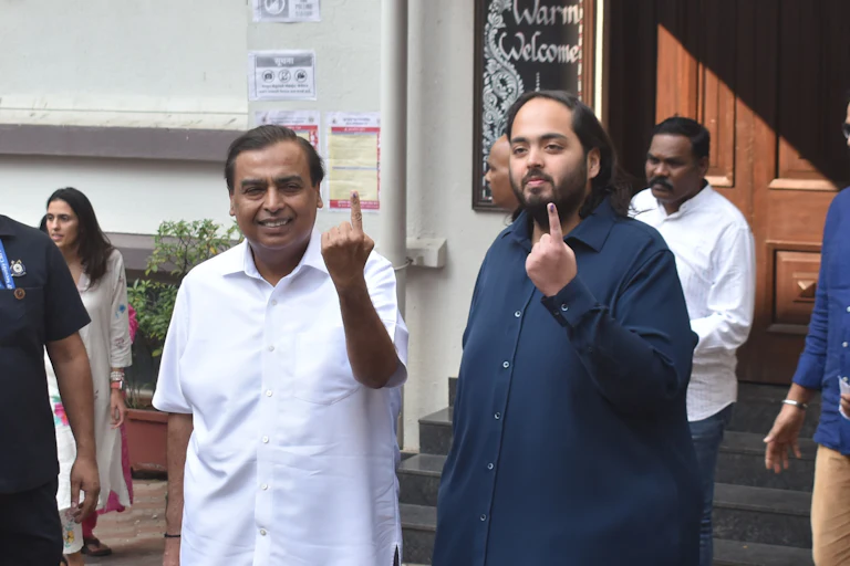 Reliance Industries Chairman Mukesh Ambani and his son Anant Ambani show their ink-marked fingers after casting their vote for the Maharashtra Assembly elections, November 20, 2024.