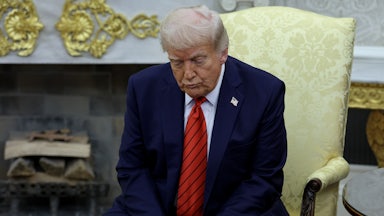 Donald Trump sits slumped in a chair, forlornly looking at the floor.