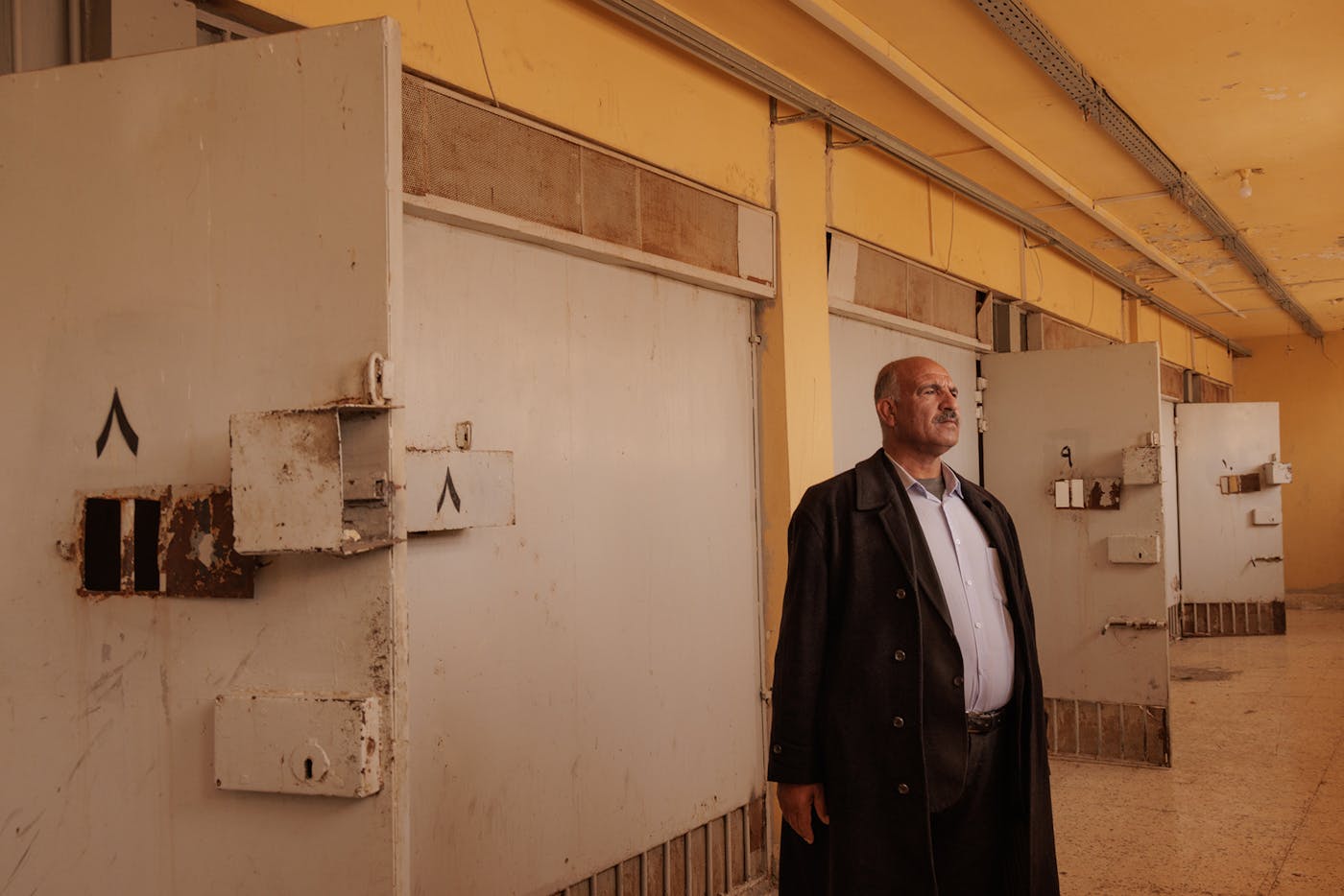 Ahmed Al Malali, age 67, from Al Kamishli, stands for a picture in a corridor of Sednaya Prison. He has come to look for his nephew, Saleh Hadeed Al Malali, born in 1980. Saleh was accused of terrorism and sent to prison in 2014. The family was notified in 2015 that he was being held in Sednaya, but since then they haven’t received any news. “I’m completely desperate, I only have hope in God," he told The New Republic. "I don’t have hope in people anymore.” 