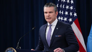 Defense Secretary Pete Hegseth stands at a podium