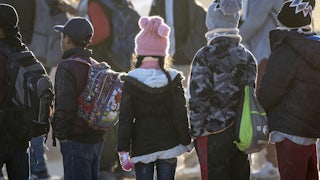 Children stand in a line.