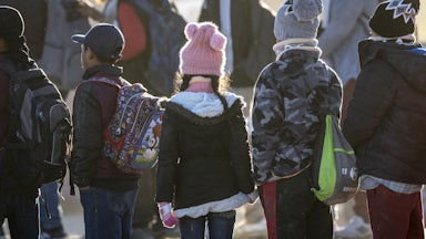 Children stand in a line.