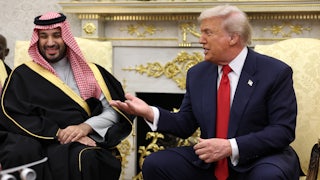 Donald Trump smiles and gestures towards Saudi Crown Prince Mohammed Bin Salman, who smiles and sits next to Trump in the Oval Office