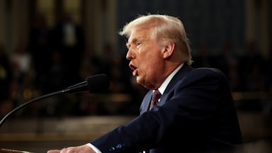 Donald Trump speaks at a podium during a joint session of Congress in the Capitol.