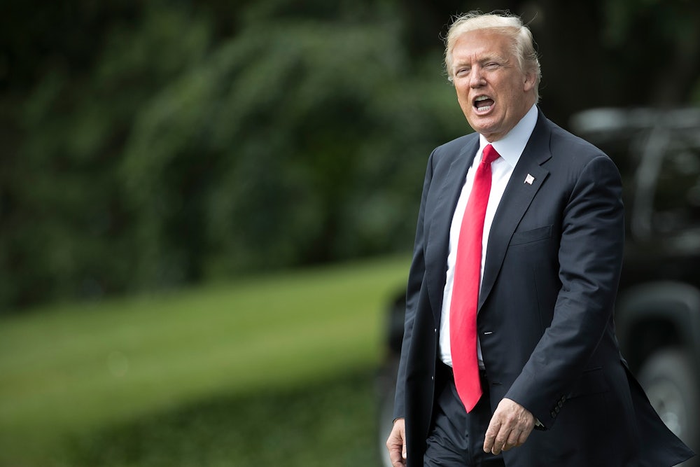 Donald Trump shouts to reporters while departing the White House.