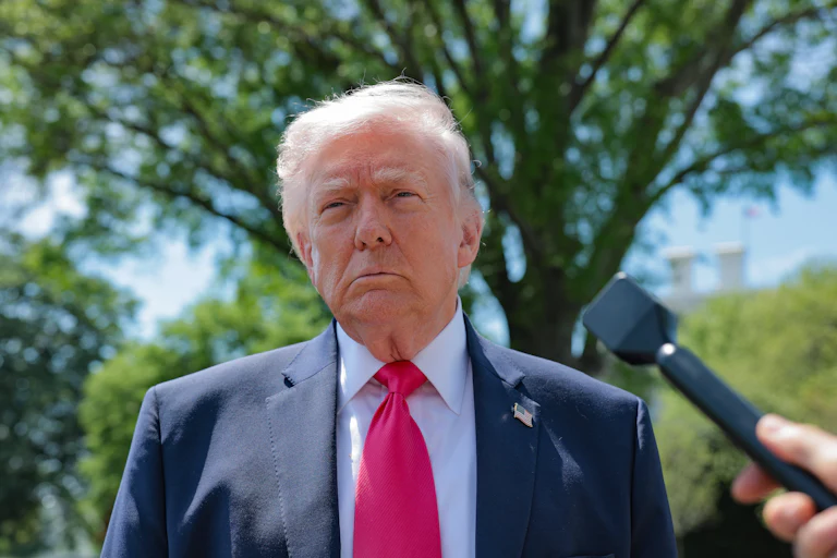 Donald Trump speaks to reporters outside the White House