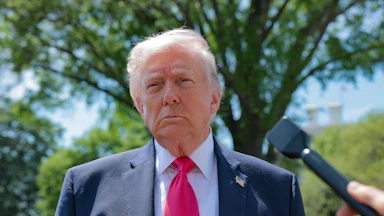 Donald Trump speaks to reporters outside the White House
