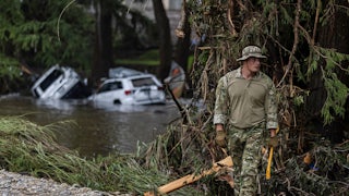 On July 6, a search-and-rescue worker looked through debris for any survivors of the Guadalupe River flooding in Hunt, Texas.