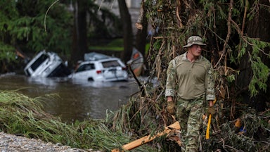On July 6, a search-and-rescue worker looked through debris for any survivors of the Guadalupe River flooding in Hunt, Texas.