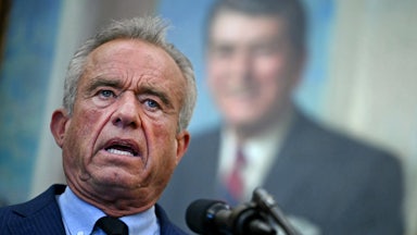 Robert F. Kennedy Jr. speaks into a microphone during an event in the Oval Office