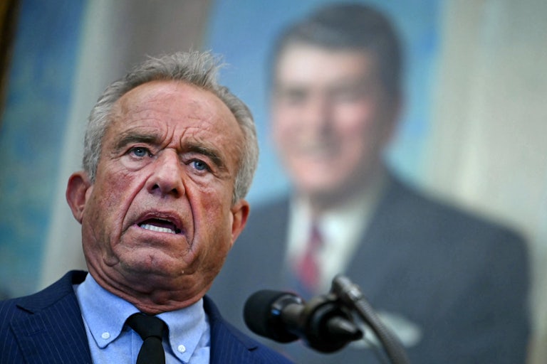 Robert F. Kennedy Jr. speaks into a microphone during an event in the Oval Office