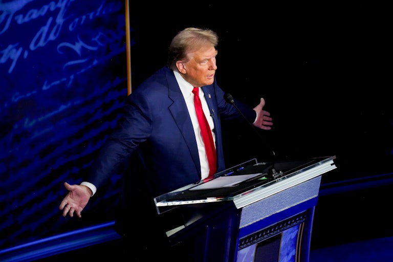Donald Trump holds his arms out during the presidential debate