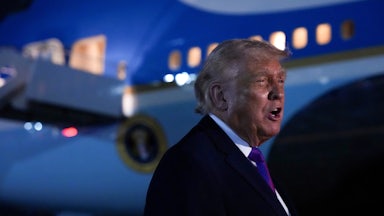 Donald Trump speaks while standing next to Air Force One